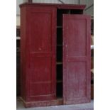 Property of a lady - a 19th century red painted pine two-door cupboard enclosing pigeon holes, one