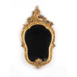 Property of a deceased estate - an early 20th century carved giltwood rocaille framed wall mirror