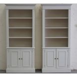 Property of a gentleman - a pair of modern cream painted open bookcases, each with two-door cupboard