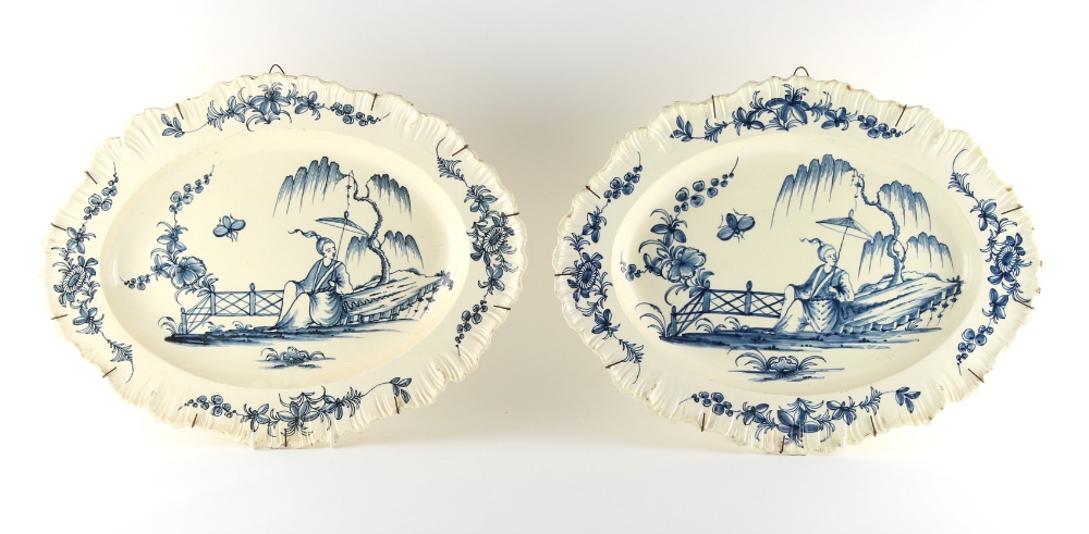 Property of a lady - a large pair of creamware shaped oval serving plates, probably Leeds, each