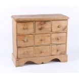 Property of a gentleman - a pine bank of nine drawers, with turned handles, 33.5ins. (85cms.)