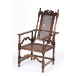 Property of a lady - an early 20th century recliner amrchair with cane panelled back & seat.