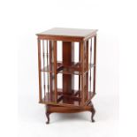 Property of a gentleman of title - an Edwardian mahogany two-tier revolving bookcase, with short