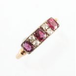 A yellow gold ruby & diamond rectangular panel ring, with three oval cut rubies of good colour,