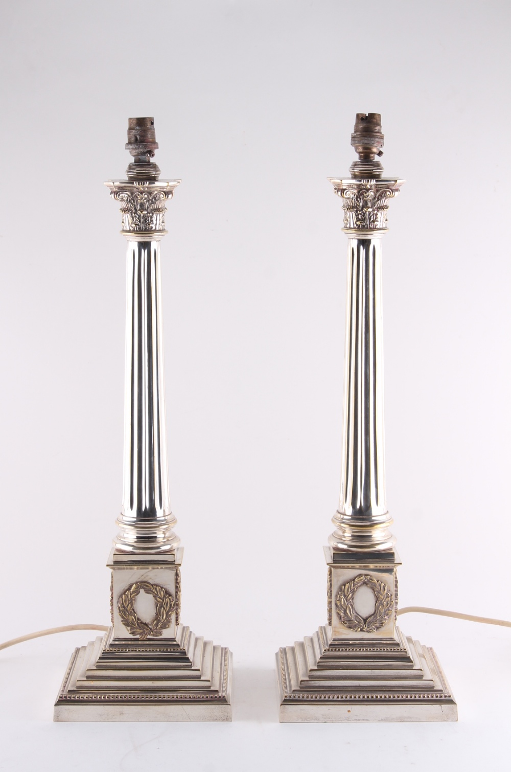 Property of a deceased estate - a pair of Edwardian silver plated Corinthian column table lamps,