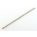 An attractive 18ct yellow gold emerald & diamond box link bracelet, the rectangular cut emeralds