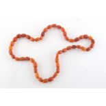 Property of a deceased estate - an amber bead necklace, two beads chipped, approximately 45 grams.