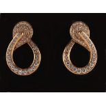 A pair of yellow gold diamond scroll earrings, each set with fifty-two round brilliant cut diamonds,