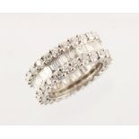 A good white gold diamond eternity ring, set with a ring of baguette cut diamonds flanked to