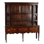 Property of a lady - a mid 18th century oak two-part dresser, the base with three drawers above a