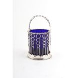 Property of a lady - an Edwardian silver pierced sugar basket, with swing handle & blue glass liner,