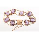 Property of a deceased estate - a 9ct yellow gold amethyst bracelet, the eight oval cut amethysts