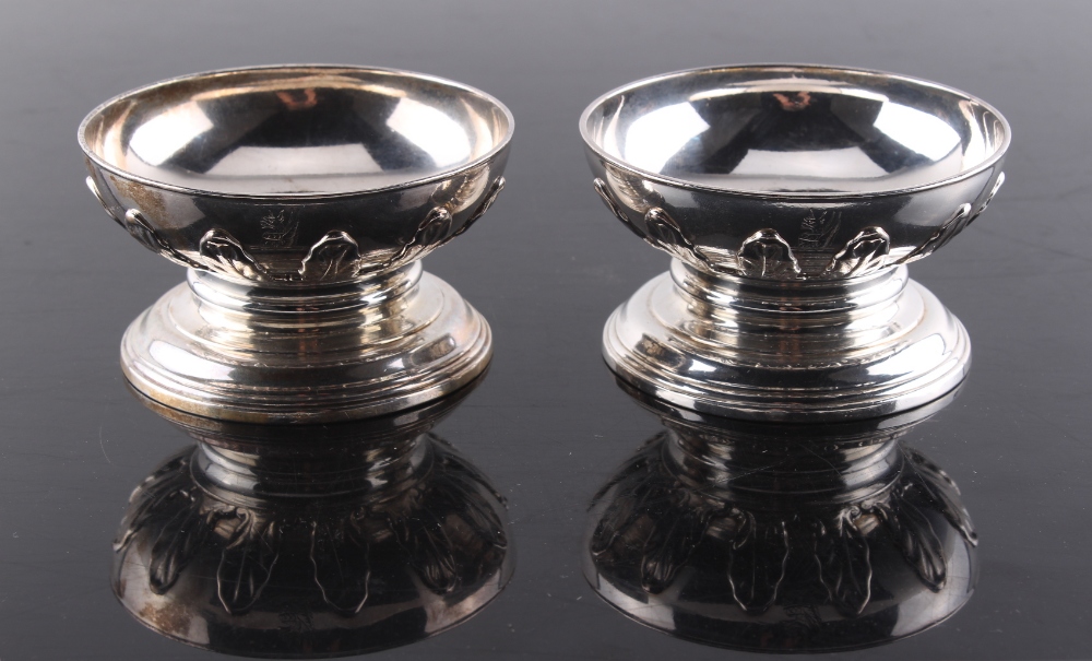 Property of a lady - a pair of silver circular pedestal salts by Anne Tanqueray, with cut card