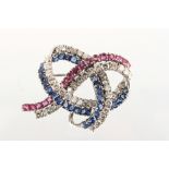 A good 18ct white gold ruby sapphire & diamond lace brooch, the seventeen round cut rubies