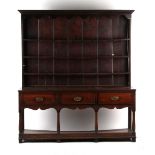Property of a gentleman - a George III oak two part dresser, of good colour, the base with three