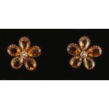 A pair of topaz & seed pearl flowerhead earrings, for pierced ears, each with five cut pear shaped