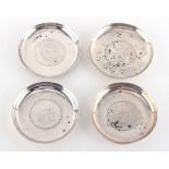 Property of a lady - four Chinese silver coin dishes by Wang Hing, the largest 3.35ins. (8.5cms.)