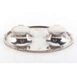 Property of a lady - a silver oval inkstand with twin hinged lidded inkwells, engraved