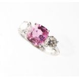 A fine white gold pink sapphire & diamond three stone ring, the untreated cushion cut pink