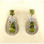 A fine pair of peridot & diamond pear shaped pendant earrings, with post & butterfly fastenings,