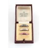 A set of three diamond ruby & sapphire eternity rings, the baguette cut diamonds weighing an