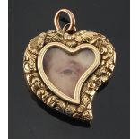 An unmarked yellow gold heart shaped pendant set with a miniature of an eye, 27mm long (excluding