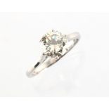 A platinum or white gold diamond single stone ring, the round brilliant cut diamond weighing