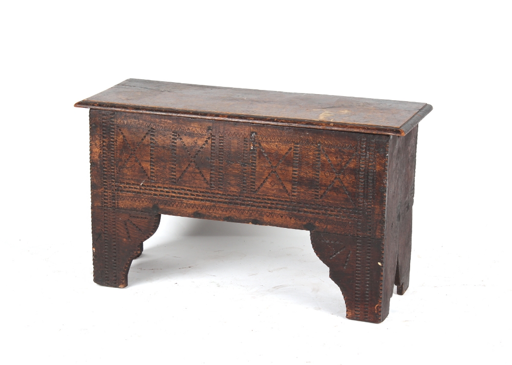 A late 17th / early 18th century oak 6-plank coffer or sword chest, with later carved decoration,