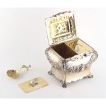 Property of a lady - a Victorian silver tea caddy of rococo form, the gilt interior with two