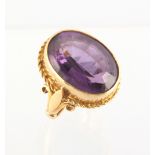 Property of a deceased estate - an 18ct yellow gold amethyst ring, the oval cut amethyst of medium