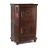 Property of a lady - a North European carved oak two-door cupboard, 18th century, with canted front,