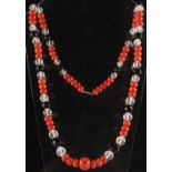 A coral jet & crystal bead necklace, the largest coral bead approximately 14mm, approximately 28ins.