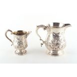 Property of a lady - two white metal jugs, each with repousse floral decoration, the larger 5.