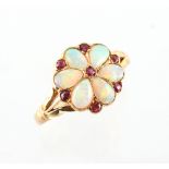 An attractive yellow gold opal & ruby flowerhead cluster ring, with six pear shaped opals