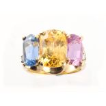 An unusual yellow gold certificated natural three colour sapphire ring, the yellow, blue & pink
