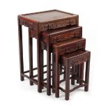 Property of a deceased estate - a nest of four Chinese carved hongmu occasional tables, the