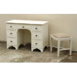 Property of a lady - a white painted kneehole dressing table; together with a similar stool (2).
