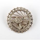 A late 19th / early 20th century unmarked gold & diamond circular brooch depicting a pond with a