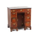 A small walnut & featherbanded kneehole desk, early 18th century & later, 30ins. (76cms.) wide (