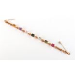 An 18ct yellow gold multi gem set bracelet, the seven various rectangular cut gems including