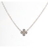 Cartier - an 18ct white gold diamond flowerhead necklace, signed & numbered, 16.2ins. (41cms.) long.