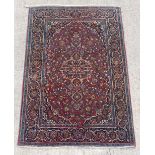 Property of a deceased estate - a Persian Kashan rug, with burgundy field, 82 by 53ins. (209 by