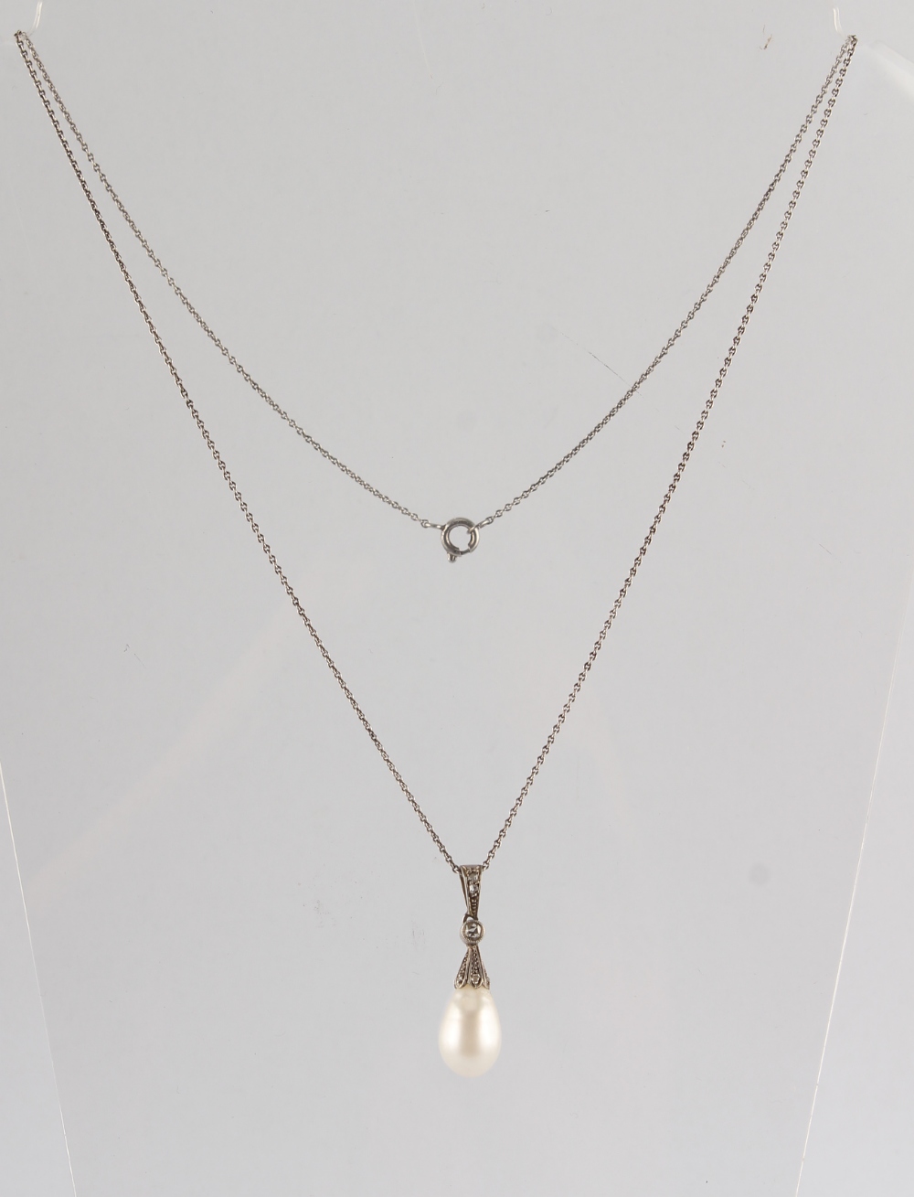 A large pearl & diamond pendant, the pear shaped pearl measuring approximately 13mm long (