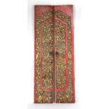 Property of a gentleman - a pair of Indian carved gilt & red painted doors, each 72.75ins. (185cms.)