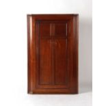 Property of a gentleman - a George III oak corner cabinet, with panelled single door, 48.25ins. (