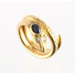 An unmarked yellow gold (tests 18ct) snake ring, with round cut diamond inset eyes & oval cushion