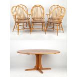 Property of a lady - an Ercol light coloured oval topped pedestal dining table, 64.5ins. (164cms.)