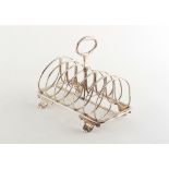 Property of a lady - a George IV silver six division toast rack, with shell feet, Sheffield 1828,