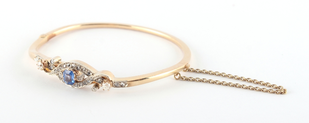 A late 19th / early 20th century 14ct yellow gold sapphire & diamond hinged bangle, the octagonal