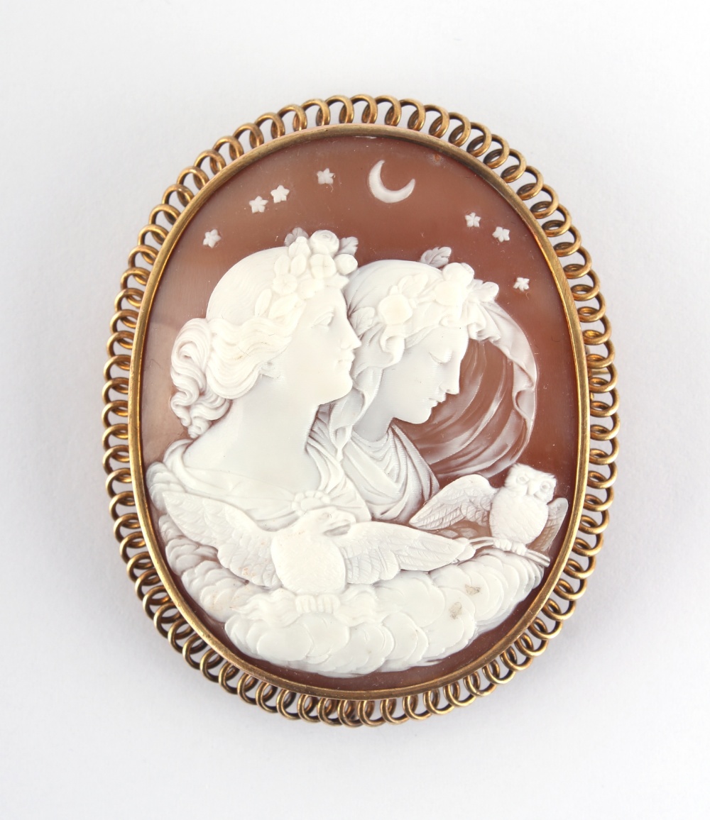 A large oval shell cameo brooch emblematic of night with two classical female figures, an eagle